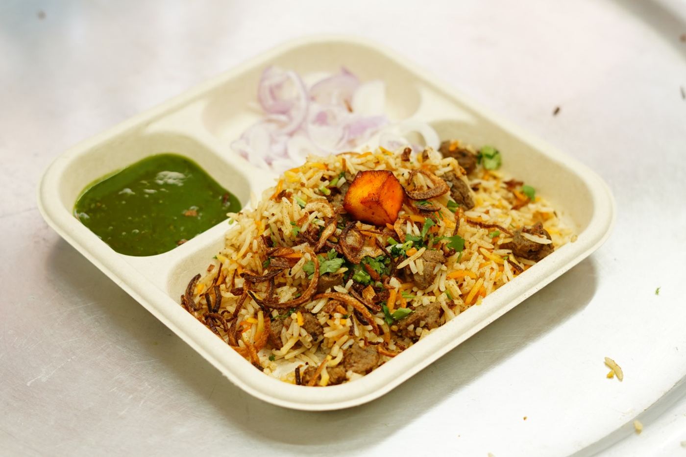 Veg soya dum biryani with green chutney and onions